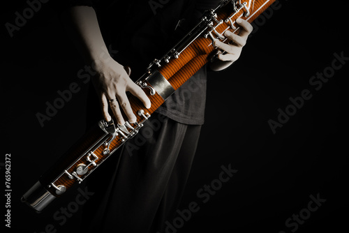 Bassoon woodwind instrument with player hands. Classical orchestral bass