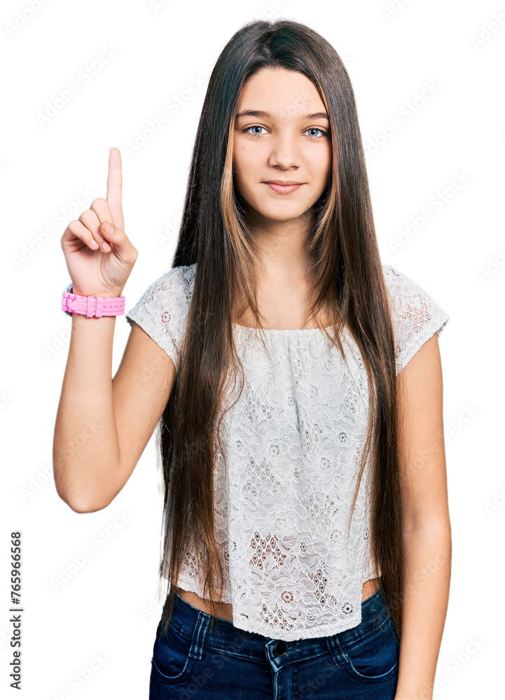 Young brunette girl with long hair wearing white shirt showing and pointing up with finger number one while smiling confident and happy. Young brunette girl with long hair wearing white shirt showing and pointing up with finger number one while smiling confident and happy.