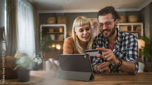 adult happy couple man and woman shopping online hold credit card photo