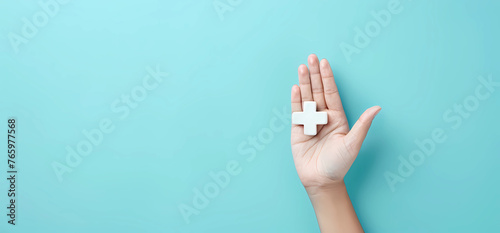Hand holding medical plus icon with blue background © Food gallery