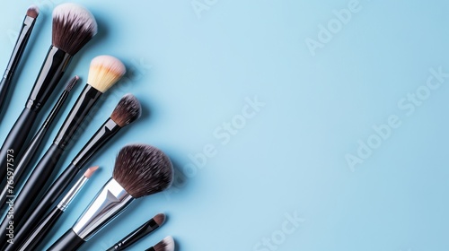 Different makeup brushes with copyspace on a light background photo