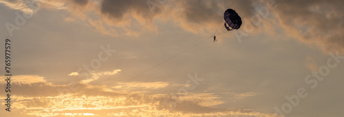 Sunset Soar: Parachute Drifting in the Evening Sky