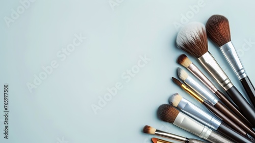 Different makeup brushes with copyspace on a light background