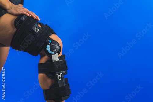 closeup shot of a knee brace with angle movement controler on a leg, medical concept. High quality photo