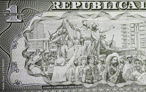 Drawing scene of Fidel Castro and his men entering Havana 1959 on  currency banknote (focus on center) photo