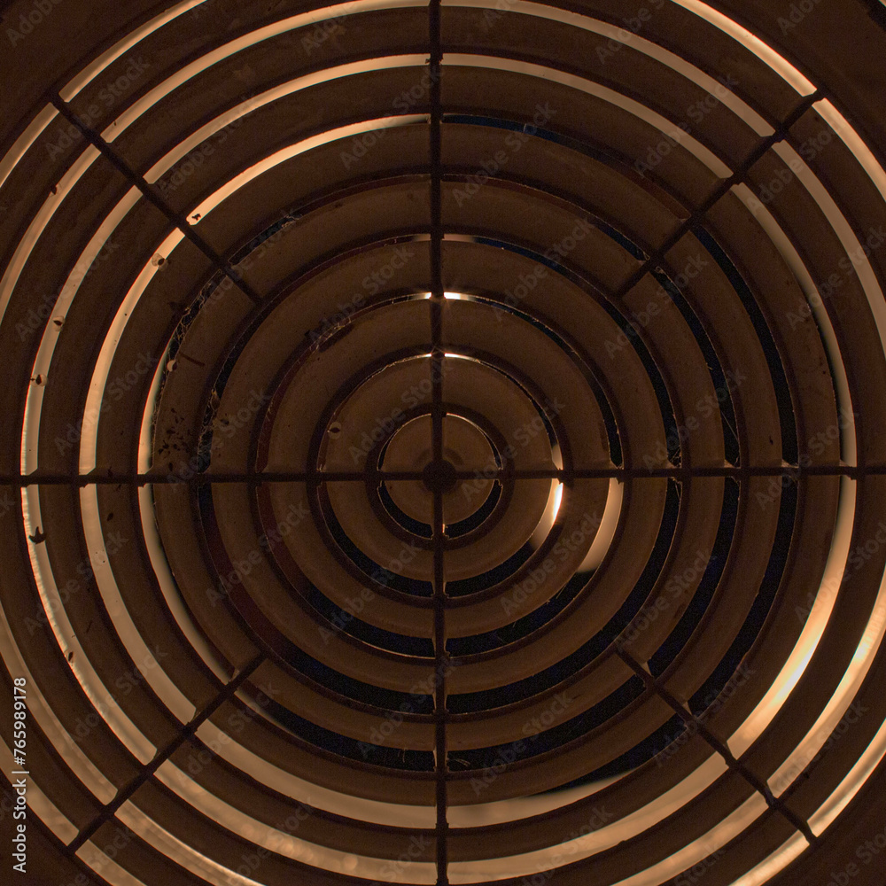 round ventilation grille at night in backlight. front and back background blurred with bokeh effect round ventilation grille at night in backlight. front and back background blurred with bokeh effect