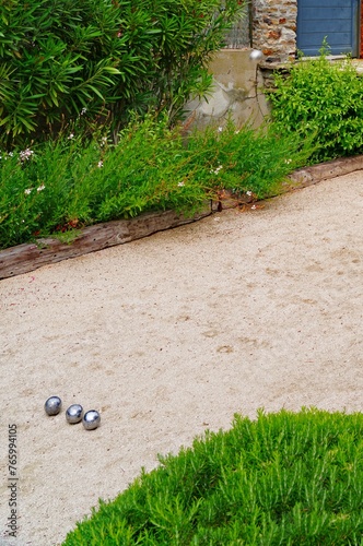Playing a game of boules bocce ball (also called pétanque) in Provence, France © eqroy