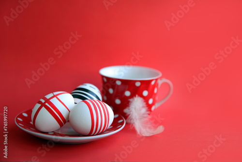 Easter composition. Easter eggs on a saucer on a red background.
