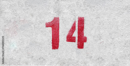 Red Number 14 on the white wall. Spray paint. photo
