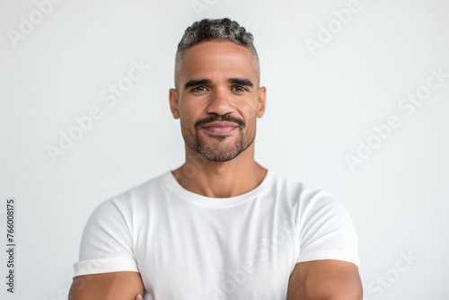 portrait of middle aged latin american man looking at camera on white background. photo