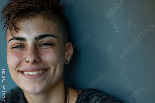 Non binary person, copy space portrait of a smiling young man leaning on a wall and lgbt sexuality and gay pride photo