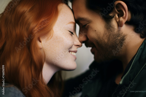 A close up of a woman with red hair smiling while tenderly kissing her boyfriend she met on a dating app online