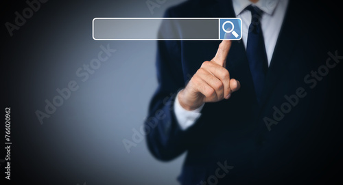 Man pointing at search bar on virtual screen against dark background, closeup. Banner design
