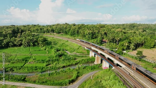Aerial View of Train Passing Through a Lush Countryside photo