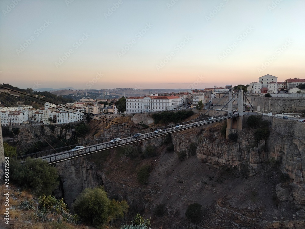 the famous suspension bridge, or footbridge of Sidi M Cid and the road which crosses the caves below at sunset, this bridge crosses the gorges at 175 meters above the Rhumel, Constantine, Algeria