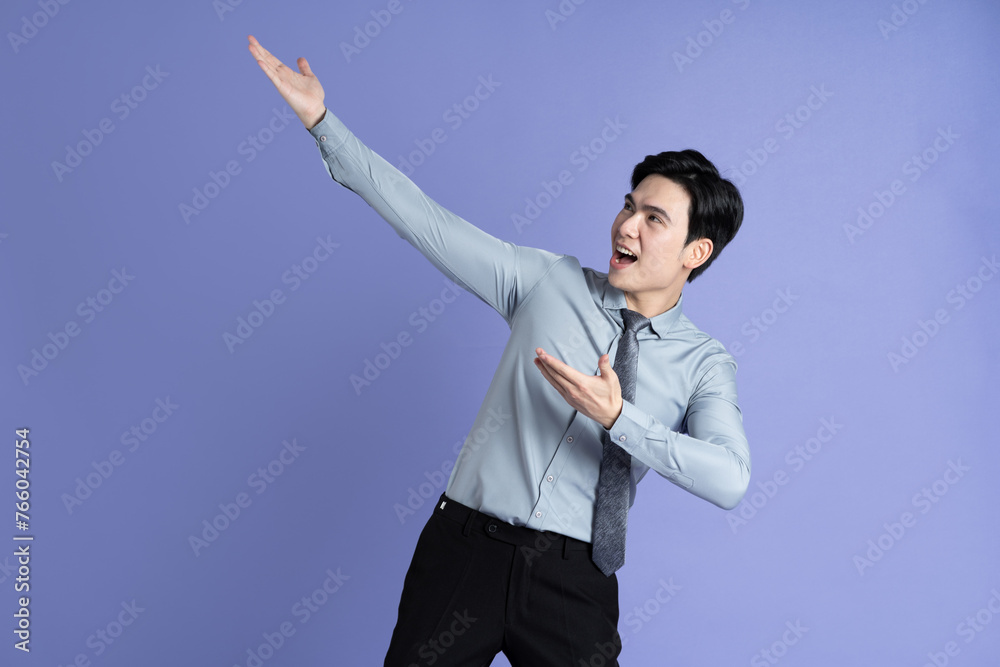 Portrait of Asian male businessman posing on purple background Portrait of Asian male businessman posing on purple background
