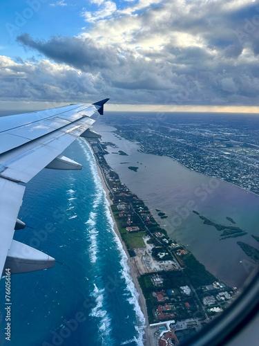 view from plane window over Palm Beach at sunrise