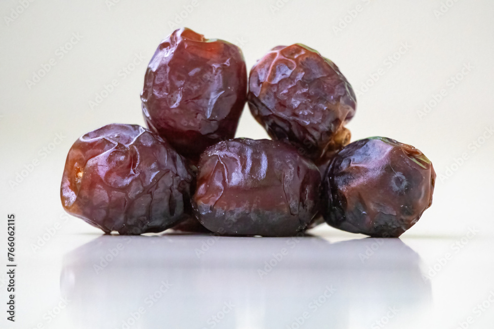 Fresh sweet date palm fruits or kurma on a wooden background. Locally in Bangladesh, it is called Khejur. Dates are high in fiber and antioxidants. Fresh sweet date palm fruits or kurma on a wooden background. Locally in Bangladesh, it is called Khejur. Dates are high in fiber and antioxidants.