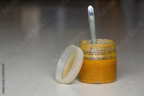 Принти на полотні A jar of ghee or clarified butter with a steel spoon on a wooden textured background