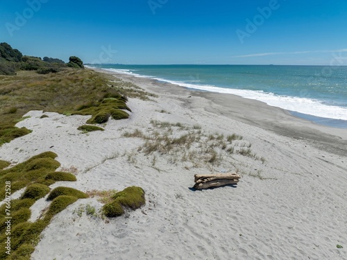 Aerial: Tussock and sandy beach in Pikowai, Bay of Plenty, New Zealand. photo