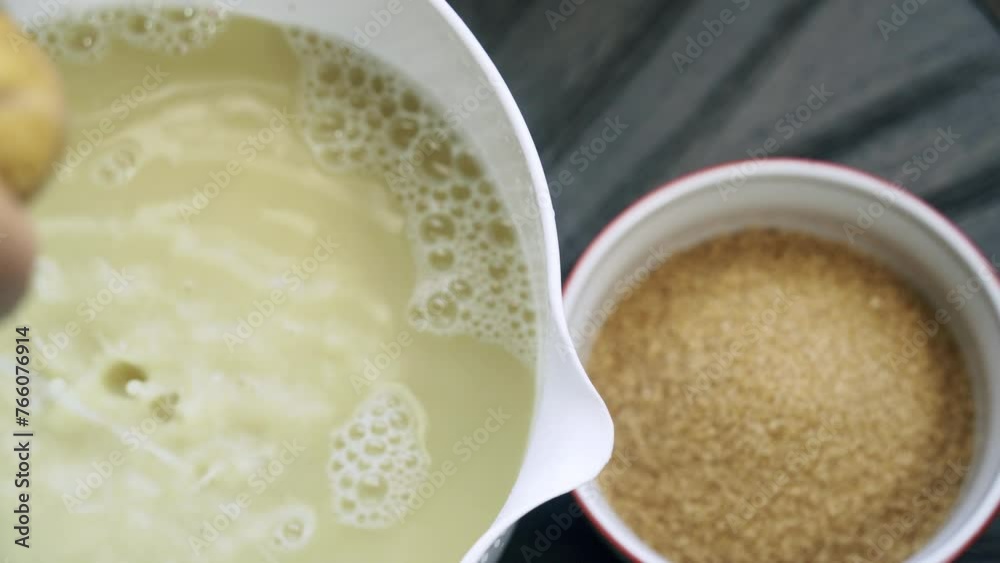 Amazing shot of ginger being juiced from a nut bag and brown sugar sitting in a bowl next to it Amazing shot of ginger being juiced from a nut bag and brown sugar sitting in a bowl next to it