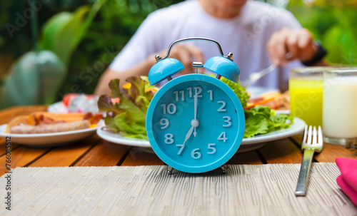 Alarm clock with IF (Intermittent Fasting) 16 and 8 diet rule and weight loss concept.-Diet plan concept photo