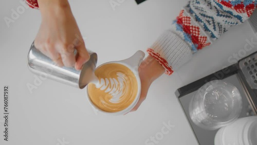 Barista serving some latte art for a customer. photo