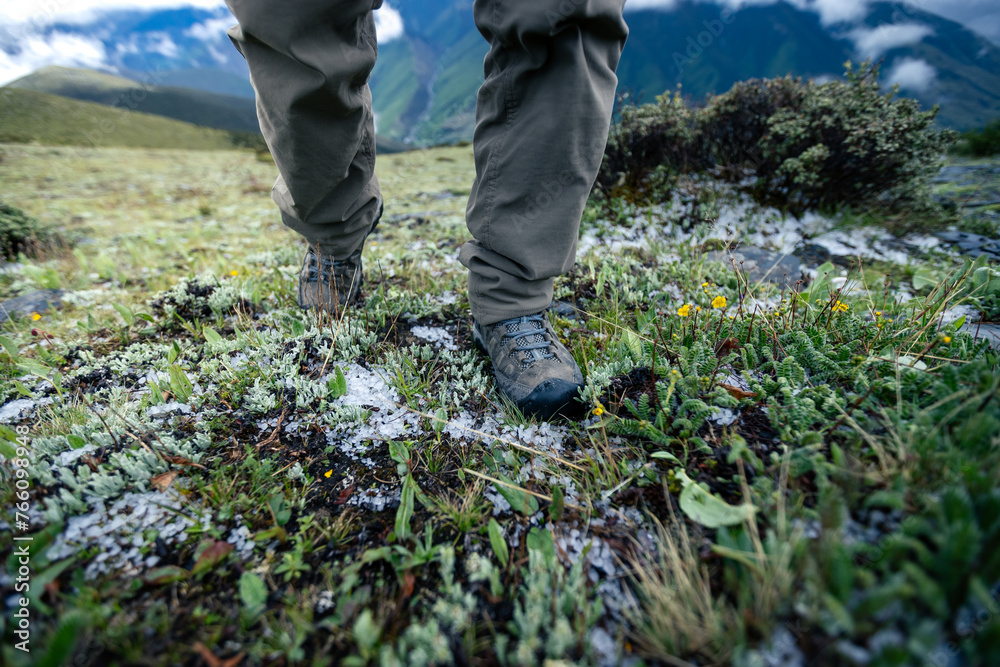 Hiking legs on high altitude mountain top Hiking legs on high altitude mountain top