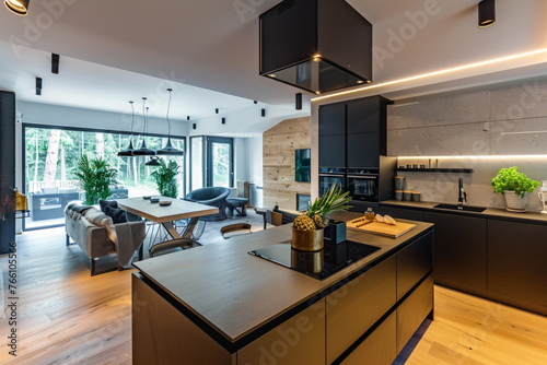 Beautiful open plan matte black kitchen and kitchen island with dining area