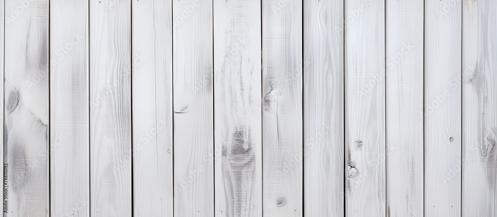 Naklejka premium A closeup of a grey rectangular wooden fence with a wood stain finish. The hardwood panels are parallel with a patterned metal font, creating a unique flooring design