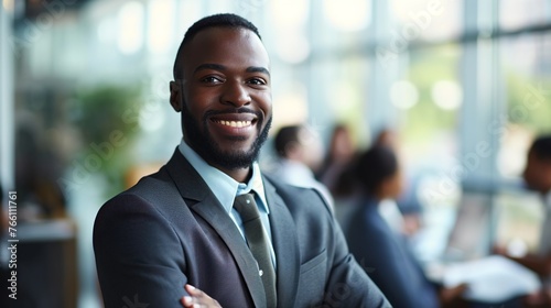 African American businessman grinning while works in the backdrop