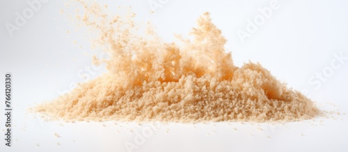 A pile of powder is being poured on a white surface, resembling snow covering a natural landscape in winter. The texture is reminiscent of soft sand © 2rogan