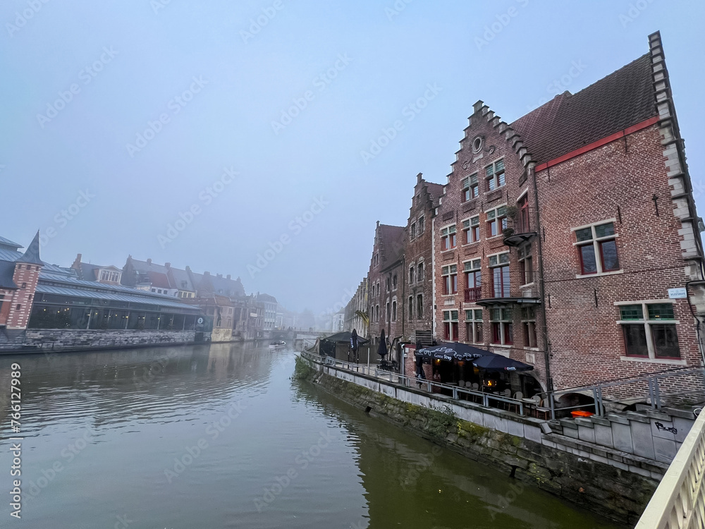 Beautiful medieval architecture and canal in ghent, belgian waterfront view