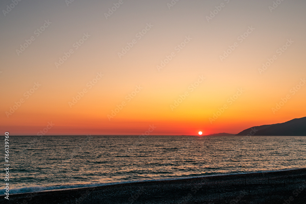 the horizon line on the sea and the sun