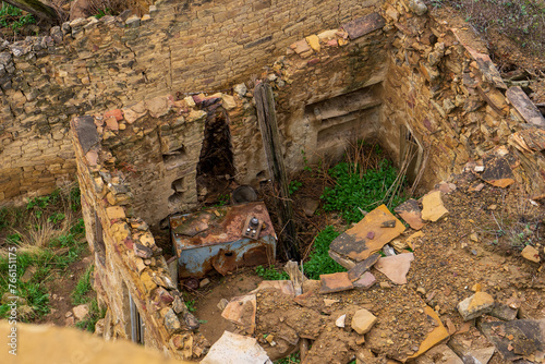 Ruins of ancient settlement in mountains. Ruined mountainous village Gamsutl in Dagestan republic. Old abandoned stone houses and buildings against spring landscape. Caucasian aul, Caucasus, Russia photo