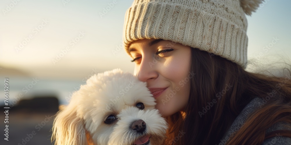 Happy young woman is sitting on the seashore on a sunny day and holding a dog in her arms. Generative AI. Happy young woman is sitting on the seashore on a sunny day and holding a dog in her arms. Generative AI.