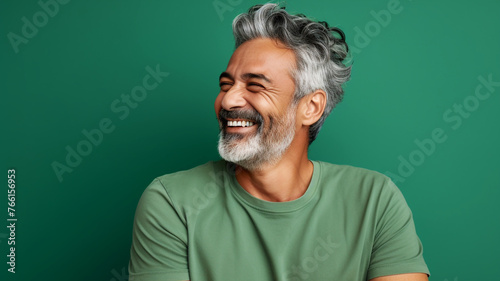 Happy smiling middle aged adult man on a solid background photo