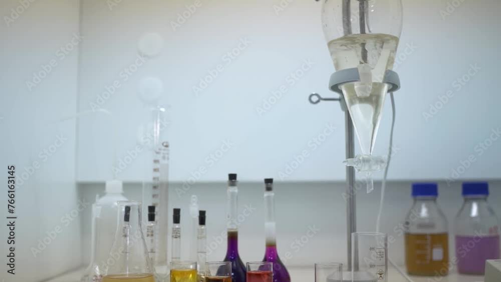 Light liquid is bubbling in a flask under laboratory conditions. Quality control in the laboratory at of sparkling . Flask is heated with large temperature on the stove in laboratory.