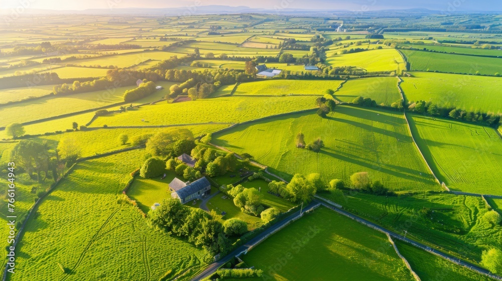 Aerial view of endless lush pastures and farmlands of Ireland. Beautiful Irish countryside with emerald green fields and meadows. - obrazy, fototapety, plakaty 