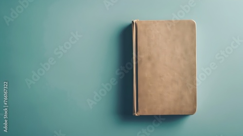 Vintage Leather Bound Book on Minimalist Teal Background