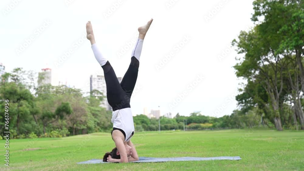 Young women have beautiful body, Playing yoga in an elegant posture, in the green park, is a concept of people's recreation and health care concept. Young women have beautiful body, Playing yoga in an elegant posture, in the green park, is a concept of people's recreation and health care concept.