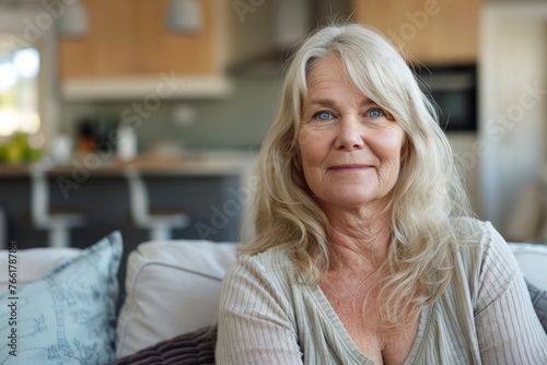 Free Download A middle aged woman is seated on the backrest of a couch in a modern living room, surrounded by furniture and decor - GFXLoad