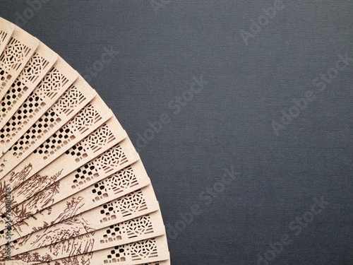Opened fan on a black background