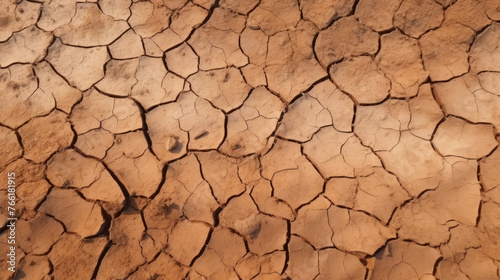 Top view photo of cracked earth, cracked soil and drought land. Texture of grungy dry cracking parched earth. Global warming effect. Ecology disaster
