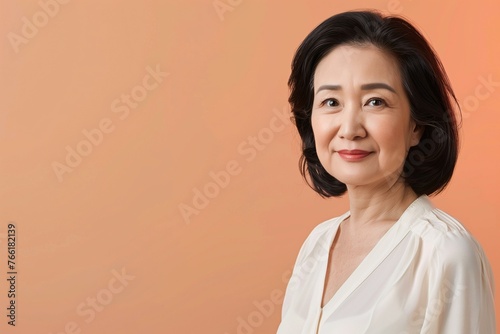 Elegant Middle-Aged Asian Woman Portrait on Coral