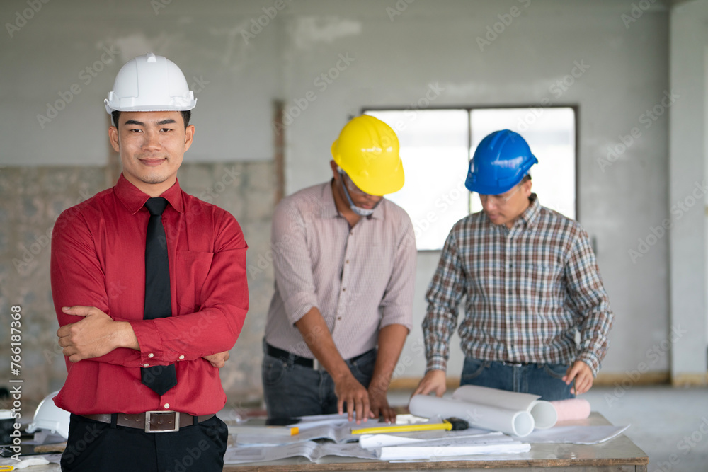 Asian engineers were consulted together and plan on the meeting outdoor in construction site, engineering and technology concept Asian engineers were consulted together and plan on the meeting outdoor in construction site, engineering and technology concept