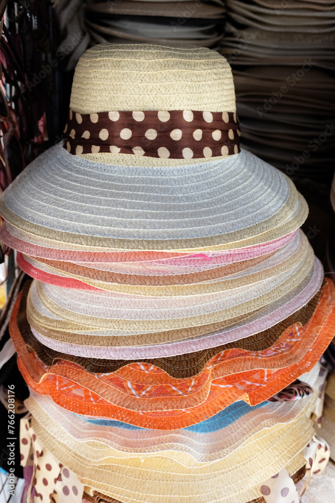 Vintage stacked straw hats in local souvenir shop in Thailand