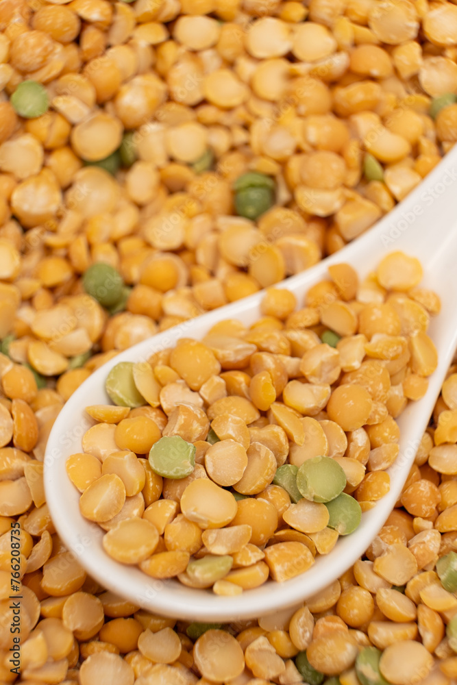 Pea yellow groats grains cereal in spoon close-up macro. Pea yellow groats grains cereal in spoon close-up macro.
