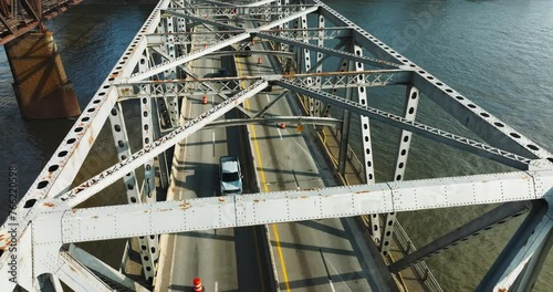 Aerial View Of Vehicles Driving Through Memphis-Arkansas Bridge Crosses Mississippi River In USA. photo