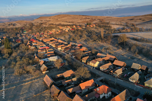Aerial view of residential houses in a village during morning sunrise lights